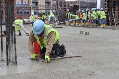 Concrete contractors finishing the concrete at the Amazon HQ2 facility.