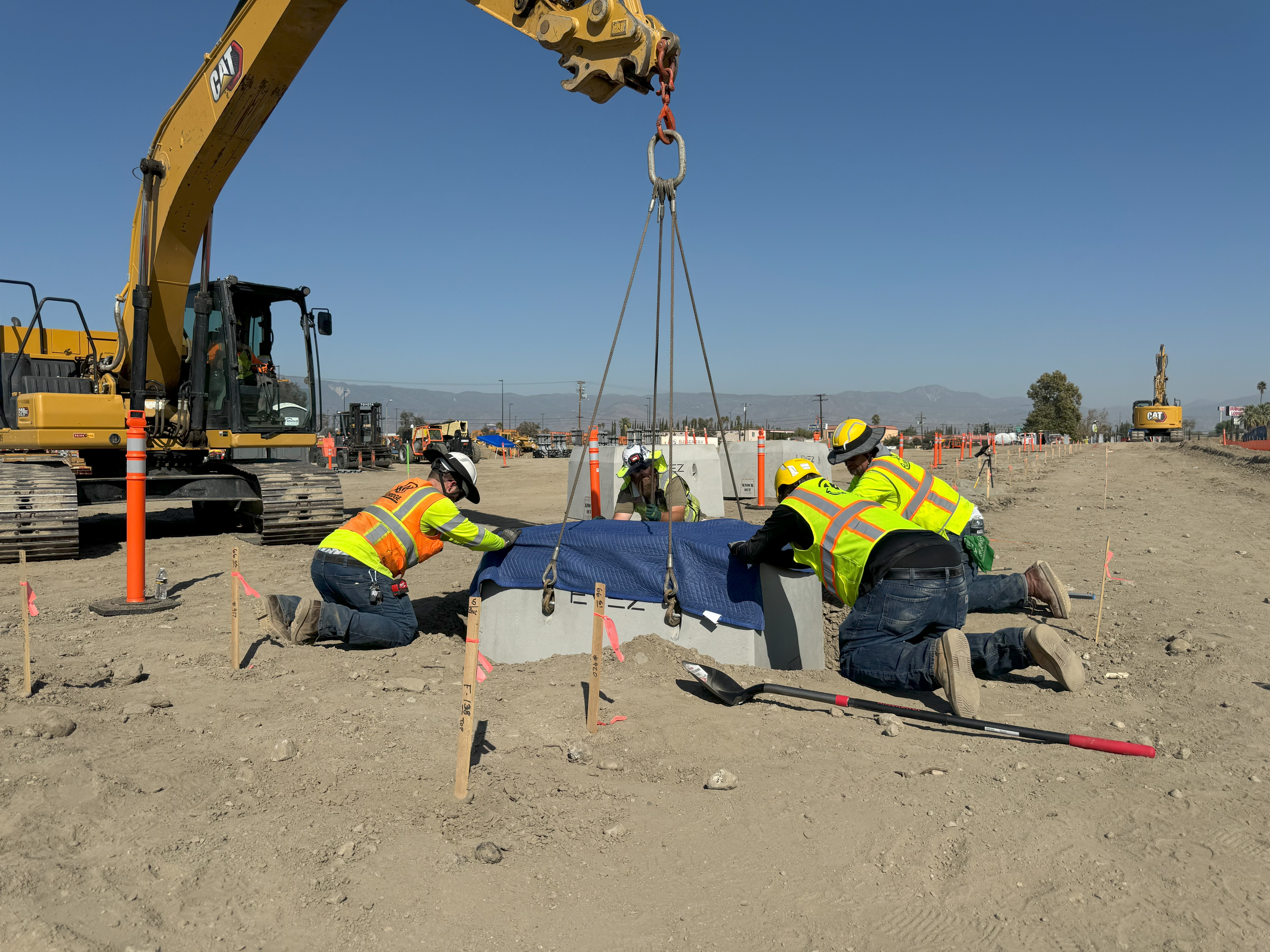 Contractors setting a precast concrete base at the Greenlane Center site in Colton, California.