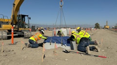Contractors setting a precast concrete base at the Greenlane Center site in Colton, California.