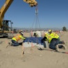 Contractors setting a precast concrete base at the Greenlane Center site in Colton, California.