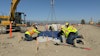 Contractors setting a precast concrete base at the Greenlane Center site in Colton, California.