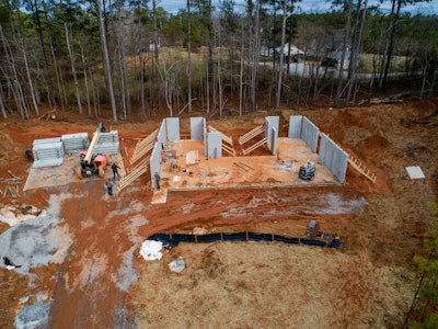These homes start with tilt-up, prestressed concrete wall panels that do not require cranes. Instead, the panels are poured on-site and moved into place using forklifts.