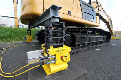 Enerpac cube jacks supporting the excavator cab during undercarriage maintenance.