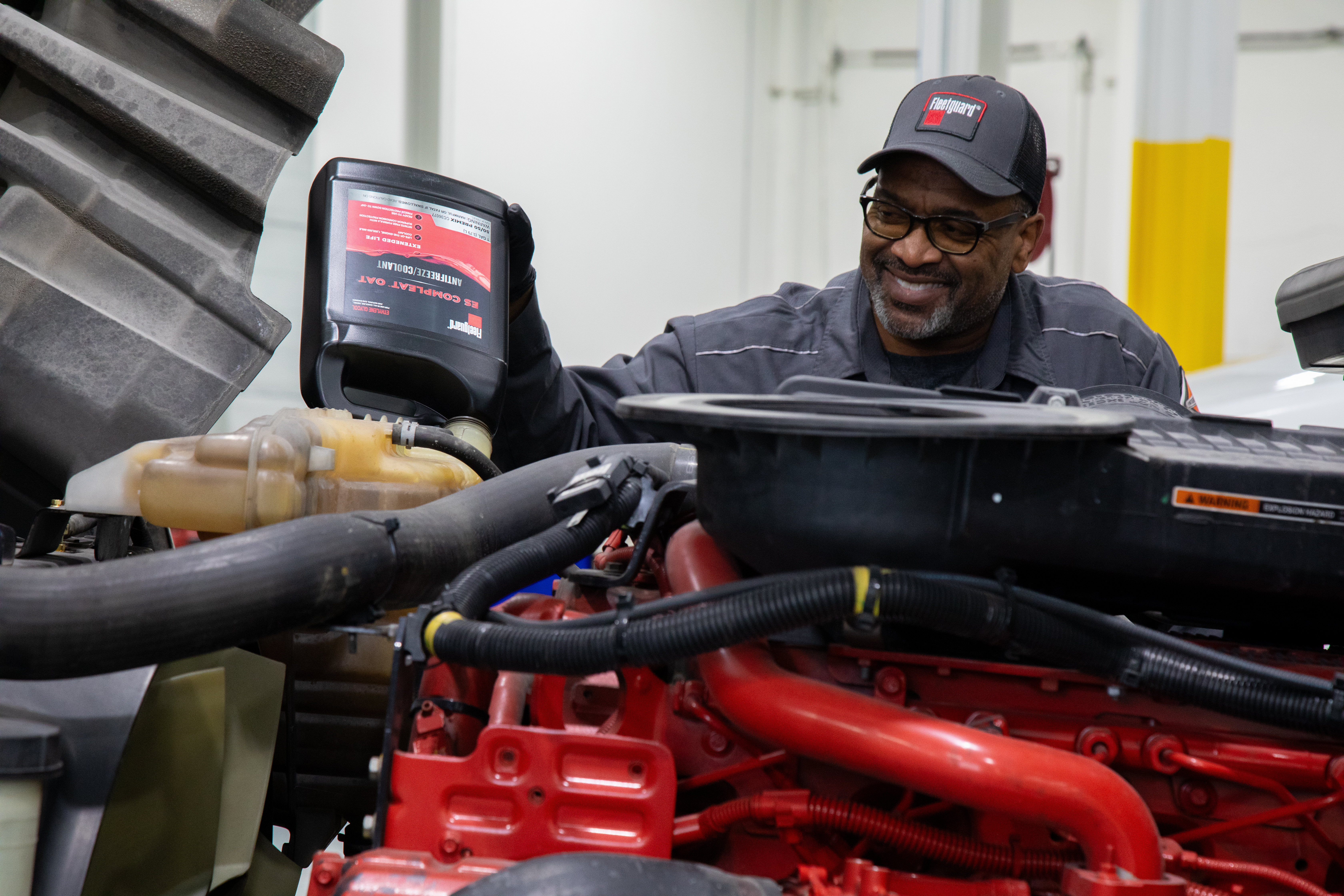Fleetguard Aa Man Pouring Coolant Smiling