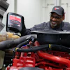 Fleetguard Aa Man Pouring Coolant Smiling