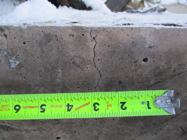 Measuring sections of discoloration, spalling, and cracking after a fire.