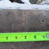 Measuring sections of discoloration, spalling, and cracking after a fire.