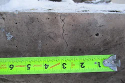 Measuring sections of discoloration, spalling, and cracking after a fire.