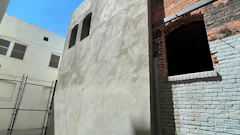 A shotcrete shear wall was installed at an existing building of unreinforced masonry for seismic strengthening.