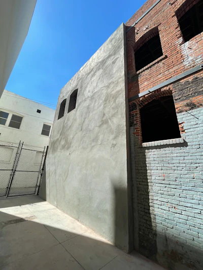 A shotcrete shear wall was installed at an existing building of unreinforced masonry for seismic strengthening.