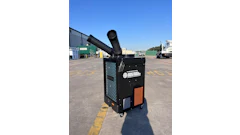 Black portable air conditioning unit with exhaust duct in industrial parking lot