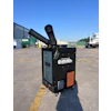 Black portable air conditioning unit with exhaust duct in industrial parking lot