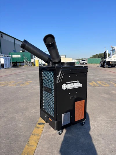 Black portable air conditioning unit with exhaust duct in industrial parking lot