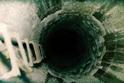 Microbially-induced corrosion in concrete creates extensive surface degradation, which can lead to widespread structural deterioration over time.