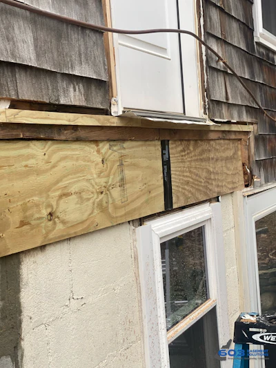 New pressure-treated sill spliced into sound framing.