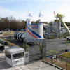 Gencor University Training Center industrial facility with blue and red striped branding, equipment towers, and flags