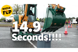 Heavy machinery dumping green container with FCP watermark overlay at outdoor event