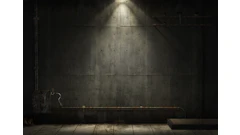 Silhouetted figure in dimly lit concrete industrial space with dramatic overhead lighting