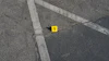 Yellow evidence marker numbered 1 on asphalt with white painted lines