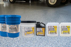 AmeriPolish concrete floor care products displayed in blue buckets and white containers on polished garage flooring