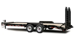 Black gooseneck flatbed trailer with dual axles and hydraulic ramps for equipment hauling