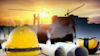 Yellow safety helmet with construction blueprints, ear protection, and workers on building site at sunset