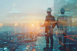 Construction workers in hard hats planning on rooftop with digital cityscape overlay at sunset