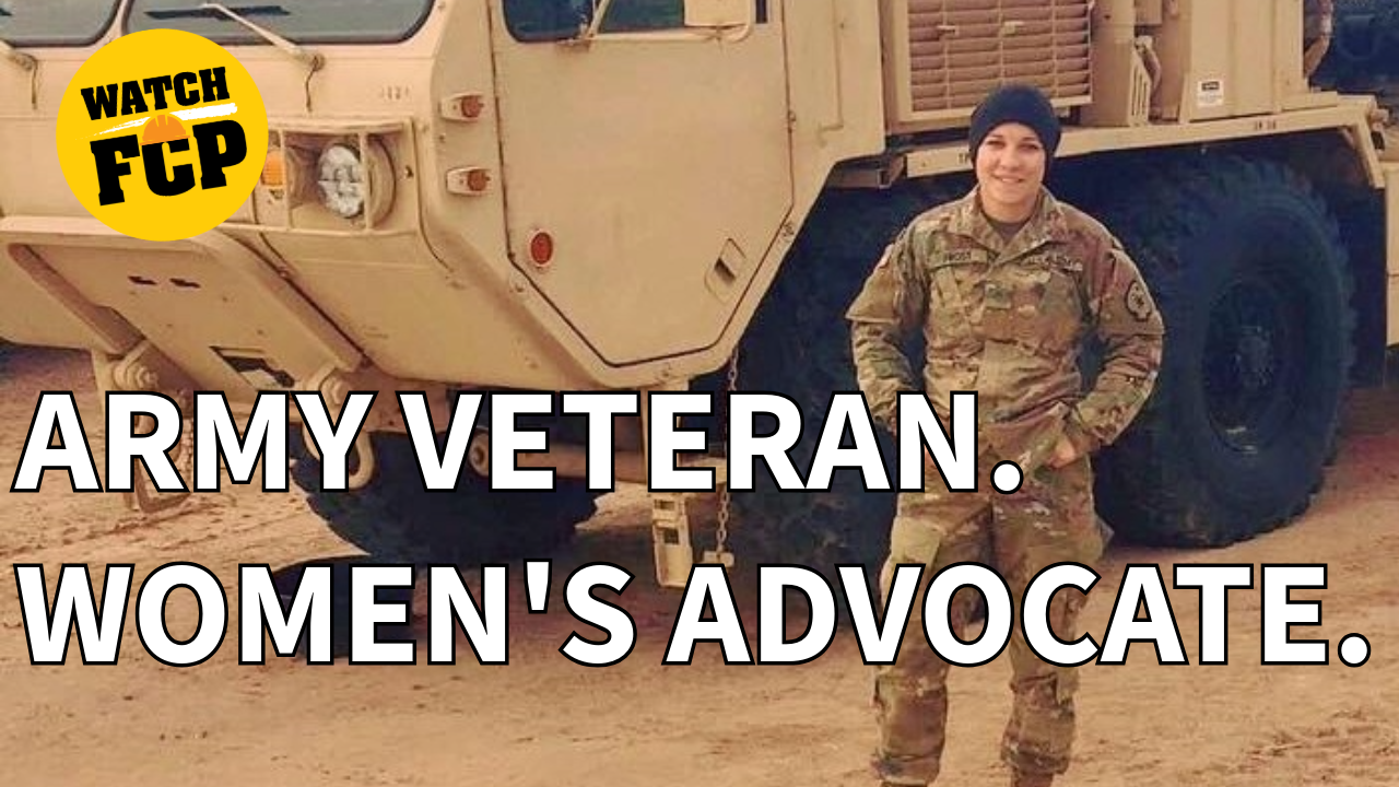 Army veteran and women's advocate in camouflage uniform standing before military vehicle