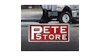 PETE Store red and white rectangular sign on pavement with delivery truck in background