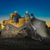 Caterpillar bulldozer with raised blade at sunset on construction site