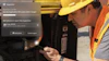 Construction worker in hard hat and safety vest inspecting hydraulic equipment during site inspection
