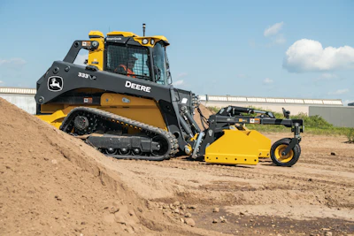 Yellow and black John Deere track loader with blade attachment on dirt site