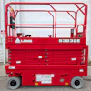 Red LGMG S3232E electric scissor lift with safety railings and control panel displayed against white garage door