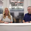 Two professionals at a broadcast desk during The Big Show Coverage event, with CAT sponsorship backdrop visible