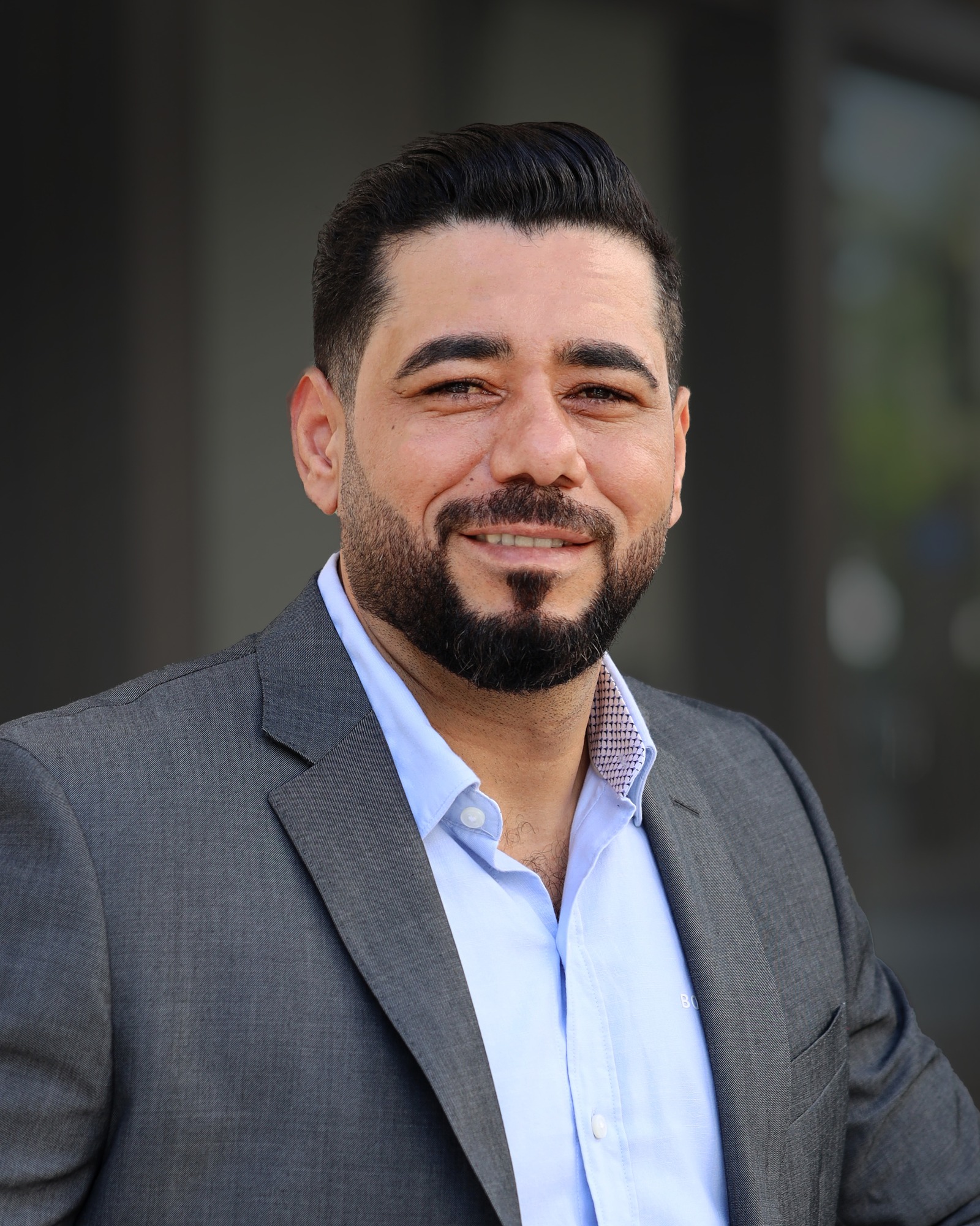 Professional headshot of a man in business attire smiling at the camera Headshot