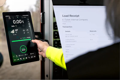 Person in yellow safety vest holding digital payment terminal displaying receipt for e-ticket transaction