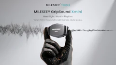 MILESEEY GripSound Xmini ultra-light wearable jobsite speaker held in gloved hand with sound waveform visualization