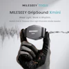 MILESEEY GripSound Xmini ultra-light wearable jobsite speaker held in gloved hand with sound waveform visualization